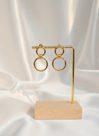 Boucles d’oreilles Énora dorées en acier inoxydable, design à deux anneaux entrelacés, longueur 3 cm, hypoallergéniques et résistantes à l’eau.